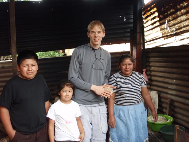 Trent in Guatemala making food in a village